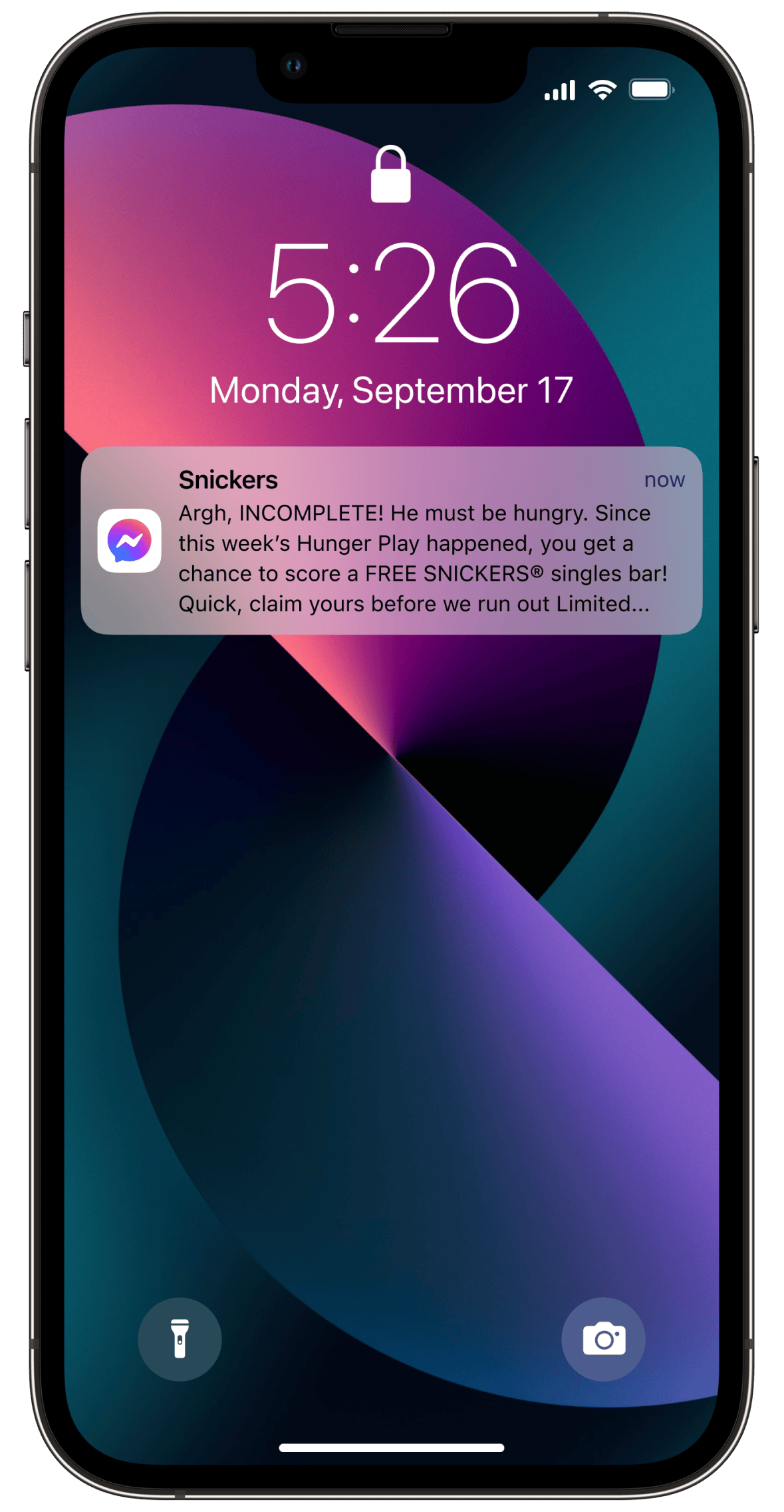 Screenshot of an iPhone lock screen with a notificaiton from SNICKERS Facebook Messenger chatbot notifying the consumer they have a chance to claim a free SNICKERS bar